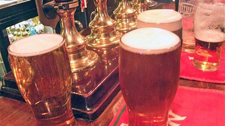 A50W49 Pints of beer on the bar London pub interior England